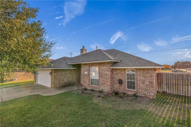 single story home featuring a garage and a front lawn