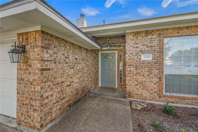 view of exterior entry featuring a garage