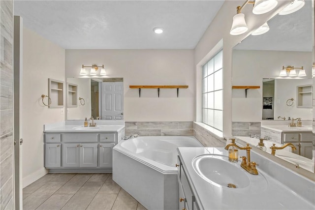 bathroom featuring vanity, a tub to relax in, and tile patterned floors