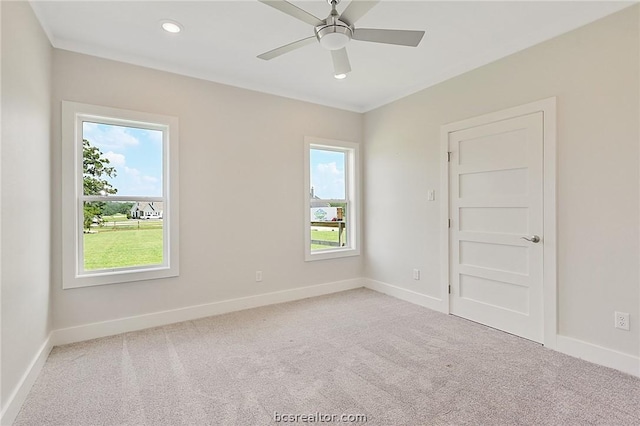 carpeted empty room featuring ceiling fan