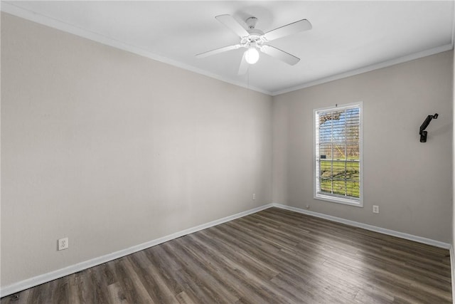 empty room with baseboards, a ceiling fan, dark wood-style floors, and crown molding