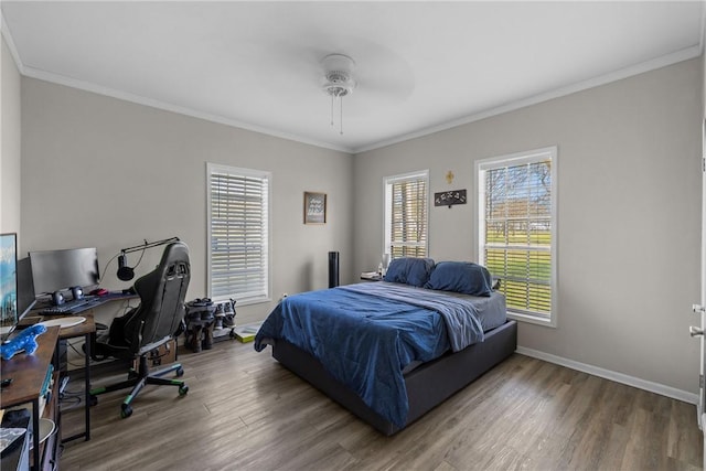 bedroom with crown molding, multiple windows, and wood finished floors