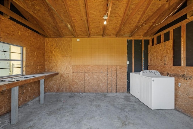 miscellaneous room featuring unfinished concrete floors and washer / clothes dryer