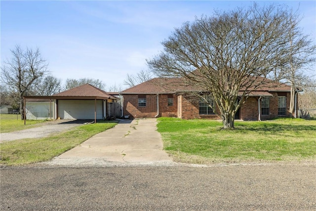 single story home featuring a garage, brick siding, and a front lawn