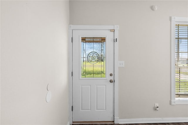 doorway to outside with baseboards