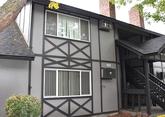 view of home's exterior with a wall unit AC