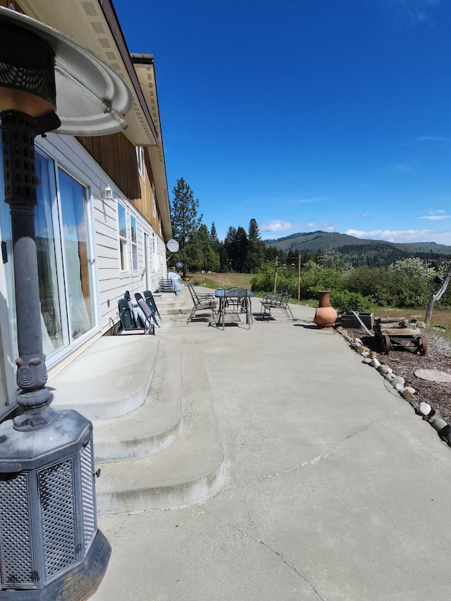 view of patio / terrace featuring a mountain view