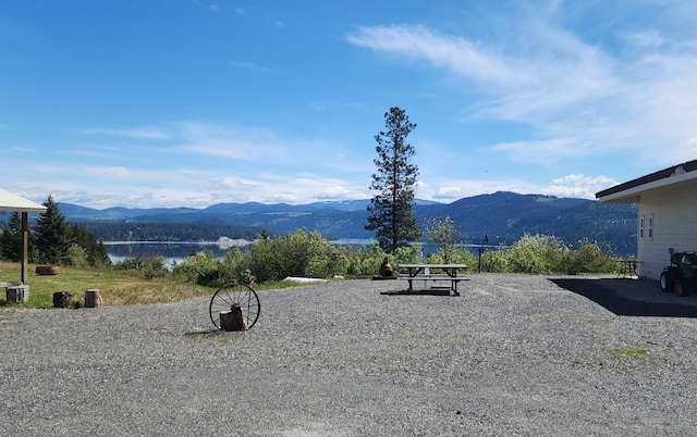 exterior space with a water and mountain view