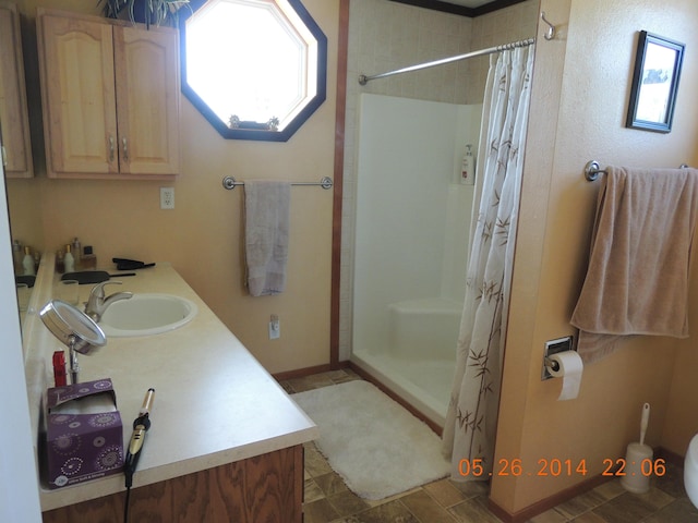 bathroom featuring a stall shower and vanity