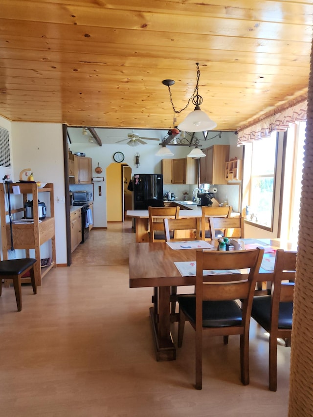 dining area featuring wooden ceiling, ceiling fan, and light wood-style floors