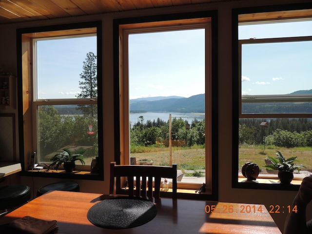 sunroom with a water and mountain view