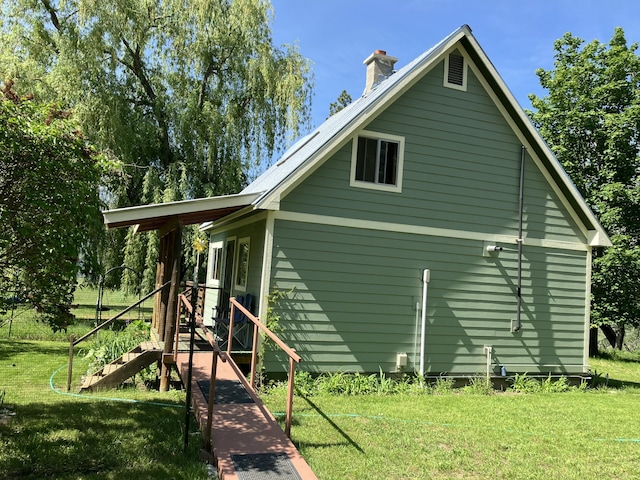 3434 Rockcut Rd, Kettle Falls, WA 99141 - view of property exterior with a lawn and a chimney