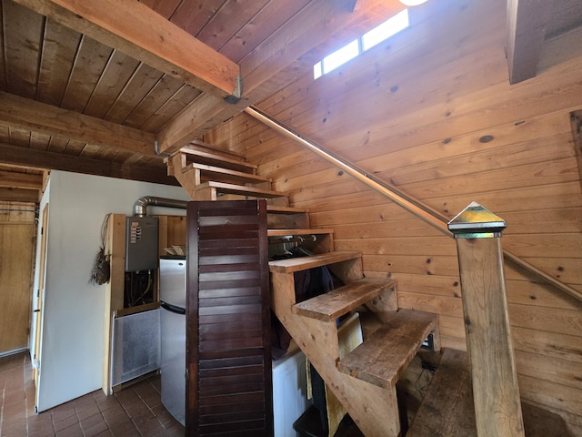 stairway featuring beam ceiling, wood walls, and wood ceiling