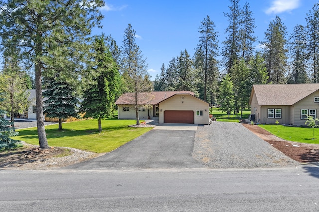 325 Hogans Way, Chewelah, WA 99109 - view of front of house with a garage, a front yard, and asphalt driveway