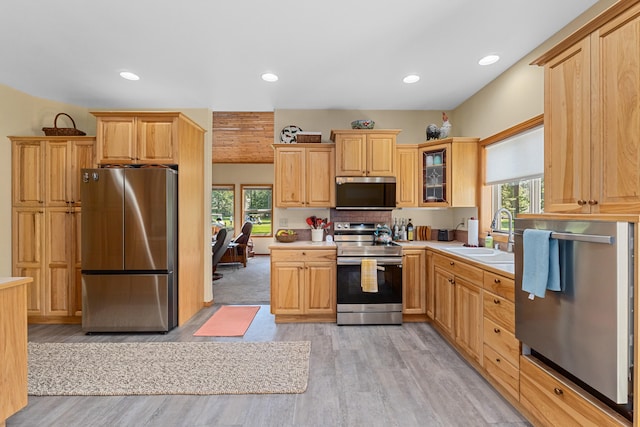 325 Hogans Way, Chewelah, WA 99109 - kitchen with appliances with stainless steel finishes, a sink, healthy amount of natural light, light wood-style floors, and recessed lighting