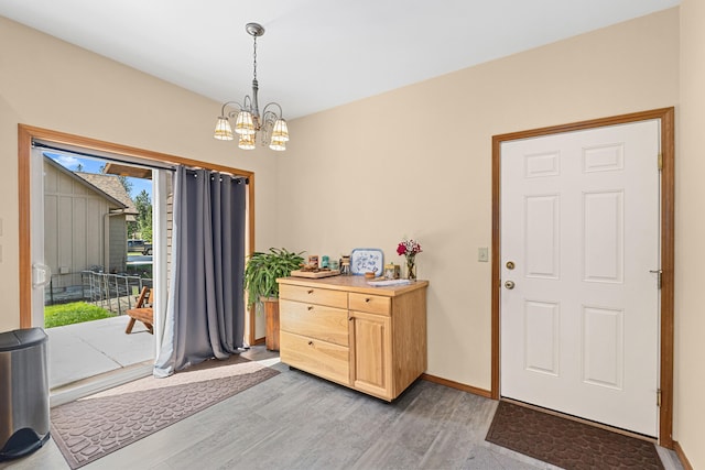 325 Hogans Way, Chewelah, WA 99109 - entryway with light wood-type flooring, a chandelier, and baseboards