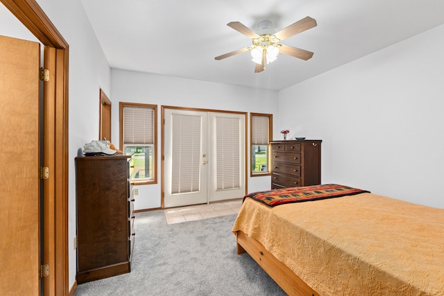 325 Hogans Way, Chewelah, WA 99109 - bedroom with light colored carpet, french doors, ceiling fan, light tile patterned floors, and access to outside