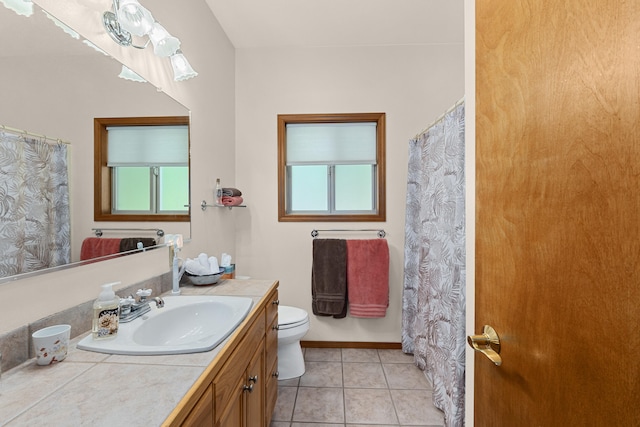 325 Hogans Way, Chewelah, WA 99109 - full bathroom with vanity, toilet, tile patterned floors, and plenty of natural light