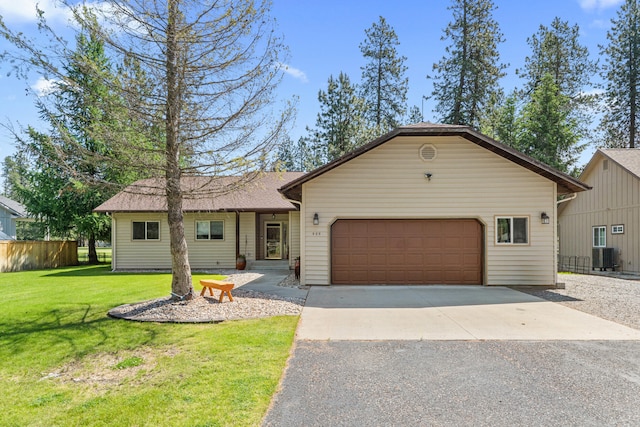 325 Hogans Way, Chewelah, WA 99109 - ranch-style home featuring asphalt driveway, a garage, a front yard, and cooling unit