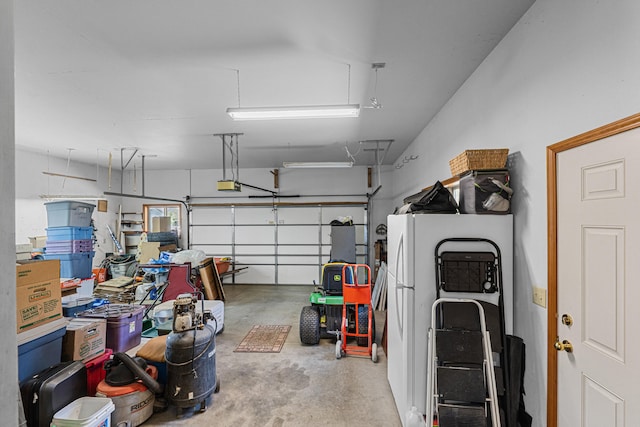 325 Hogans Way, Chewelah, WA 99109 - garage with freestanding refrigerator and a garage door opener