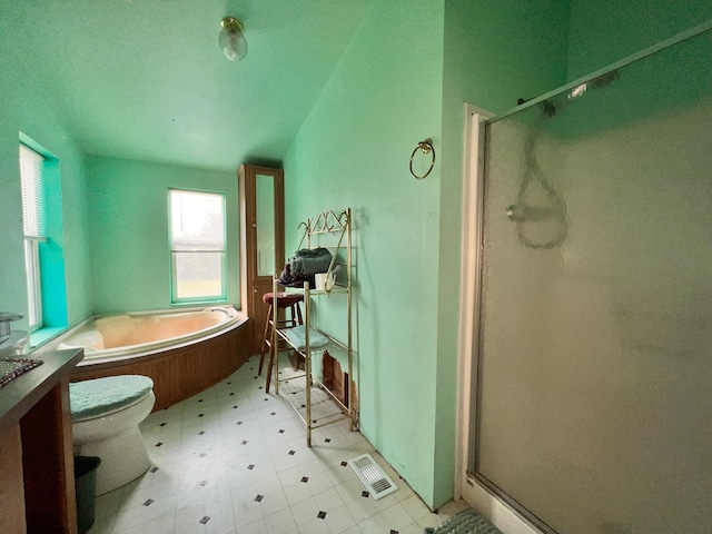 bathroom with toilet and shower with separate bathtub