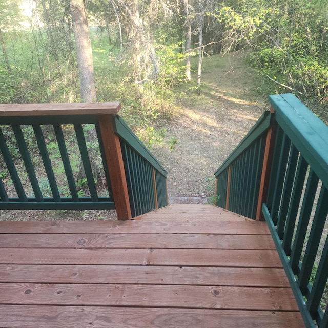 wooden deck with a view of trees