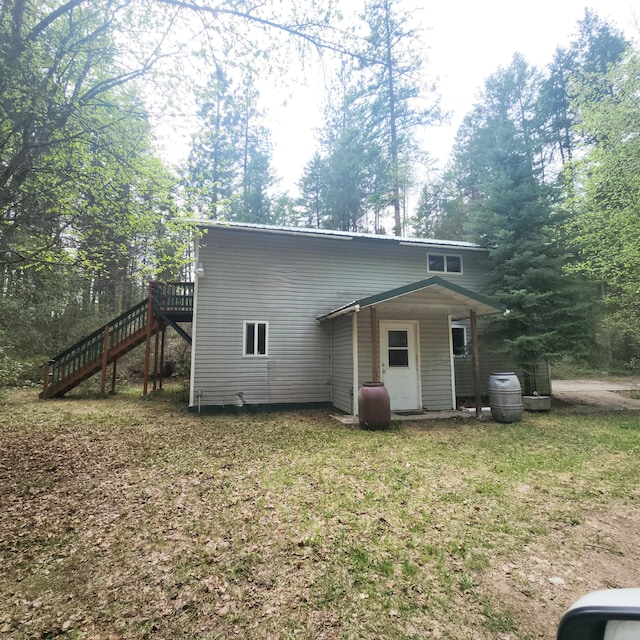 back of house with stairs