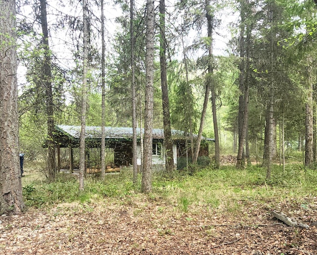 exterior space featuring a wooded view