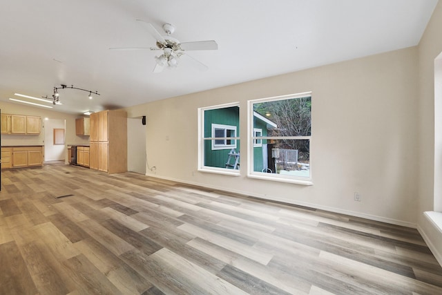 4087 Hesseltine Rd, Valley, WA 99181 - unfurnished living room featuring vaulted ceiling, ceiling fan, baseboards, light wood-style floors, and track lighting