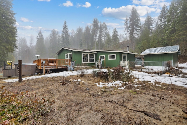 4087 Hesseltine Rd, Valley, WA 99181 - snow covered property featuring a hot tub, fence, central AC unit, and a deck