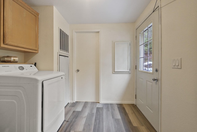 4087 Hesseltine Rd, Valley, WA 99181 - laundry room featuring cabinet space, washer / dryer, baseboards, and wood finished floors