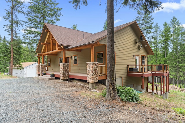 1157 Orin-Rice Rd, Colville, WA 99114 - view of front facade with a wooden deck, roof with shingles, and an outdoor structure