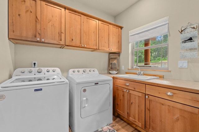 1157 Orin-Rice Rd, Colville, WA 99114 - washroom with cabinet space, separate washer and dryer, and light wood finished floors