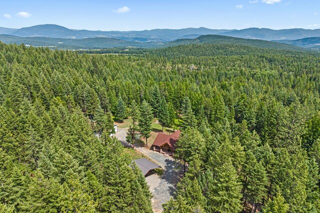 1157 Orin-Rice Rd, Colville, WA 99114 - drone / aerial view of a heavily wooded area and a mountain backdrop