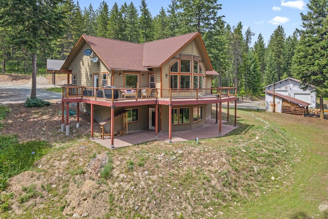 1157 Orin-Rice Rd, Colville, WA 99114 - rear view of house with a wooden deck, a lawn, roof with shingles, and a view of trees