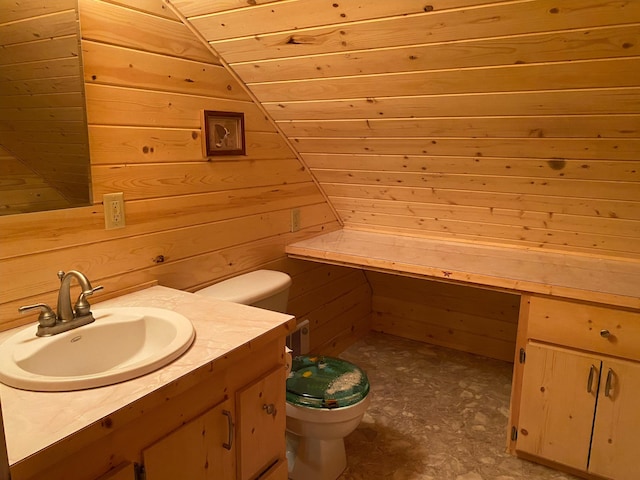 3164 Denney Ranch Way, Kettle Falls, WA 99141 - bathroom featuring toilet, lofted ceiling, wooden walls, and vanity