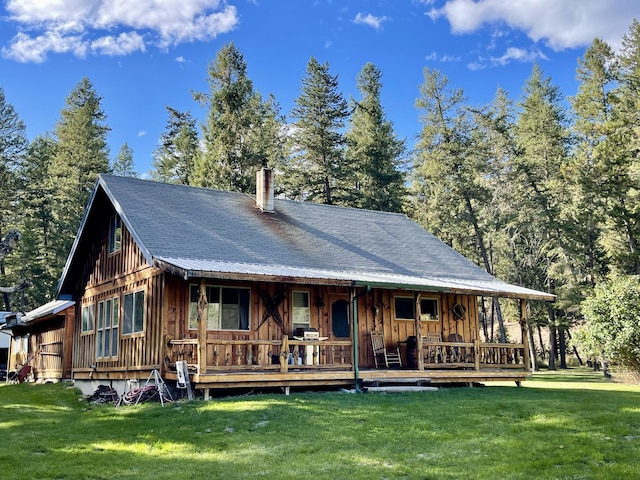 rear view of property with a lawn and a porch