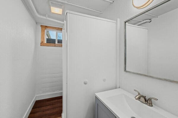 bathroom featuring vanity and hardwood / wood-style floors