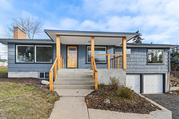 view of front of house with a garage and a porch