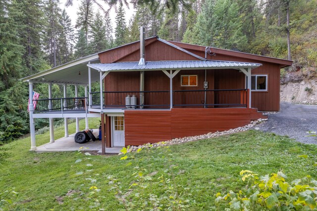 view of home's exterior featuring a lawn and a patio