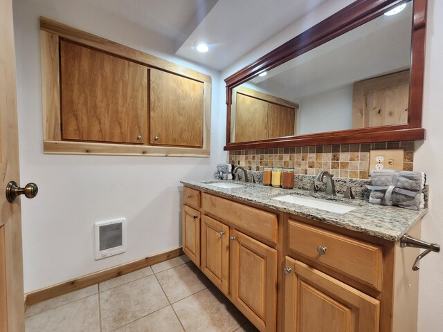 bathroom featuring backsplash, tile patterned floors, and vanity