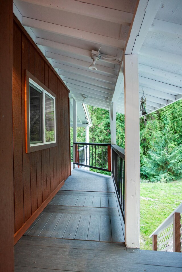 wooden terrace featuring ceiling fan