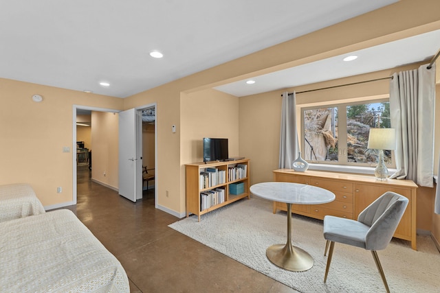 interior space with recessed lighting, concrete flooring, and baseboards