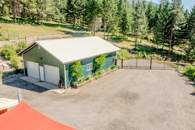 detached garage featuring a gate and fence