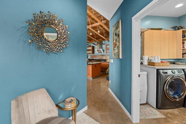 washroom featuring baseboards, washer and dryer, and laundry area