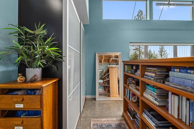 interior space with baseboards and a high ceiling