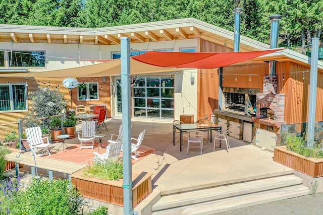 view of patio featuring an outdoor brick fireplace