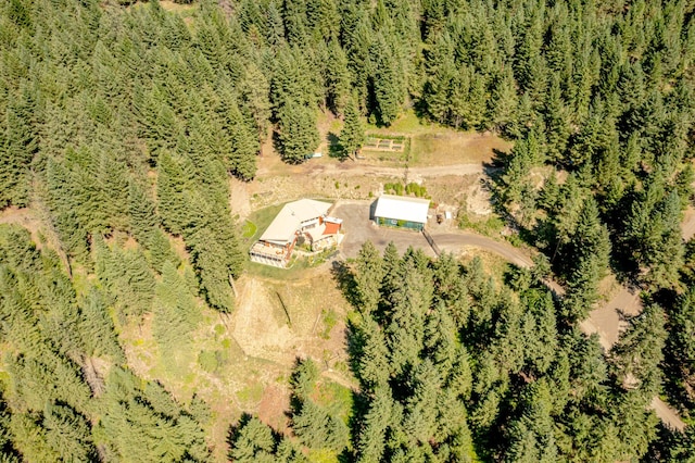 drone / aerial view featuring a wooded view