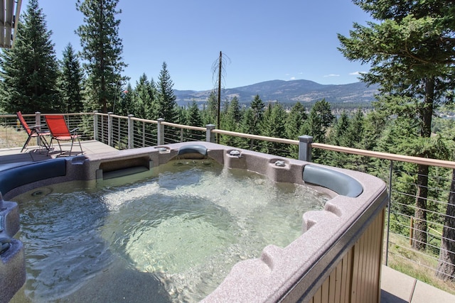exterior space featuring a mountain view and a hot tub