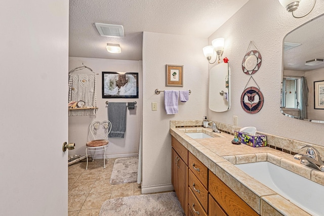 bathroom featuring vanity and a textured ceiling